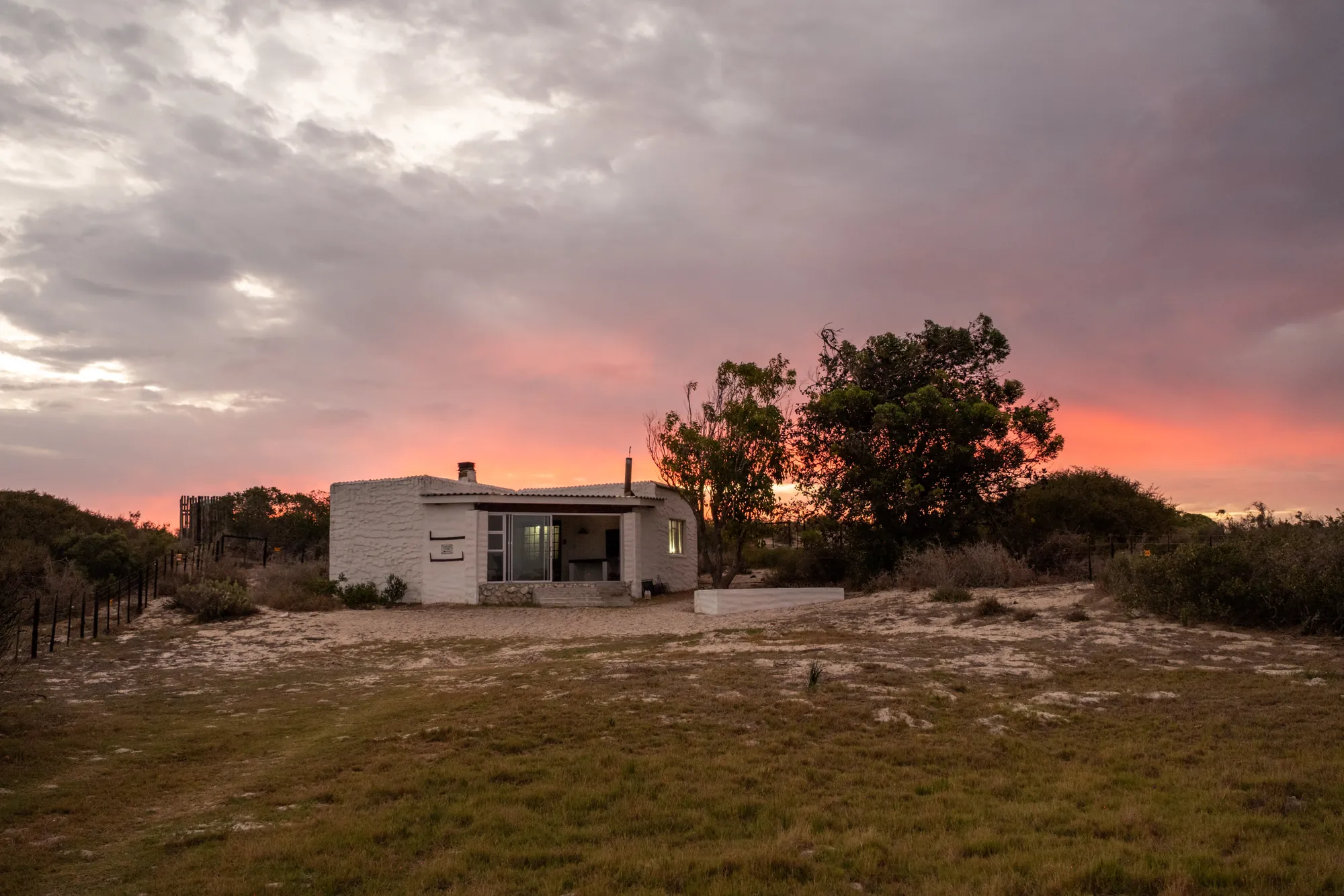 Lumberjack Cottage on the open veld under a dramatic evening sky